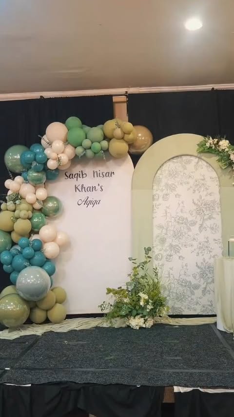 Custom backdrop with organic sage balloon garland