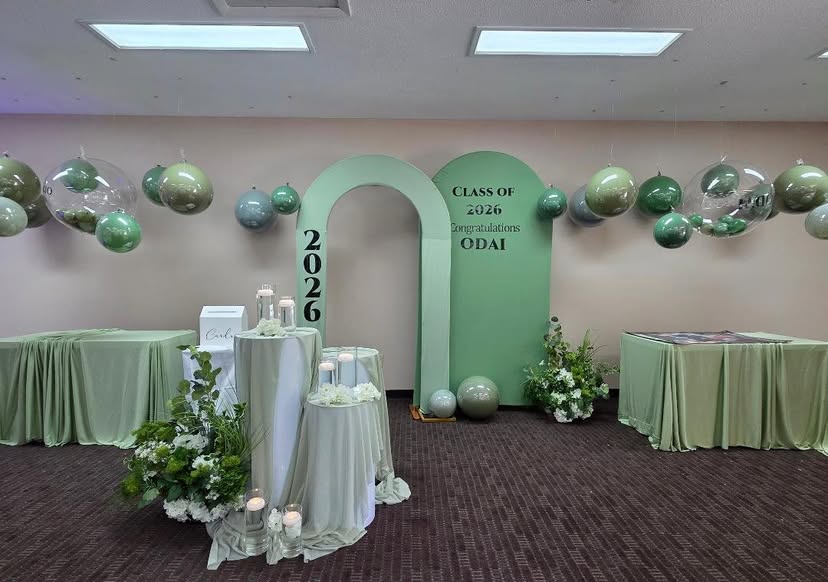 Full room styling with hanging balloons and draped tables