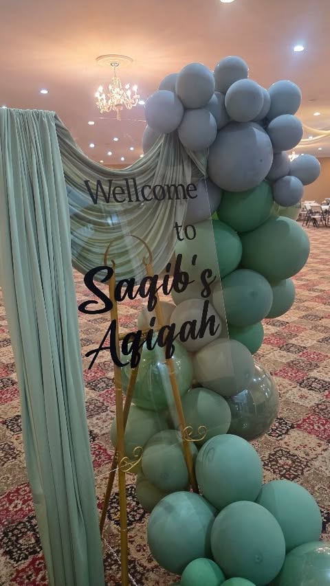 Acrylic welcome sign with drapery and balloon column